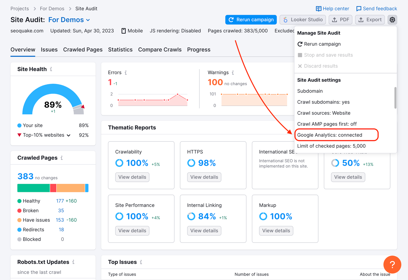Site Audit Overview with a red arrow pointing to the Google analytics integration in the drop-down settings menu in the top-right corner. 