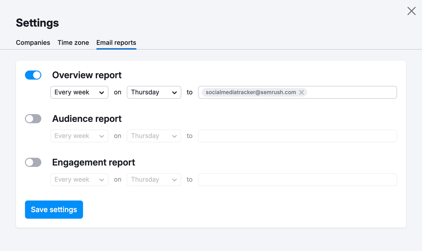 Email reports tab of the Settings menu of Social Tracker. There are three toggleable options: Overview report, Audience report, and Engagement report. Each report type has selectable frequency, day, and an email address field.